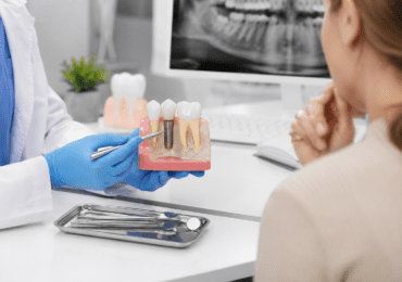 Dental consultation with implant model demonstration